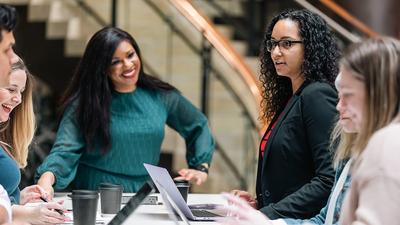 Group of women working together with laptops