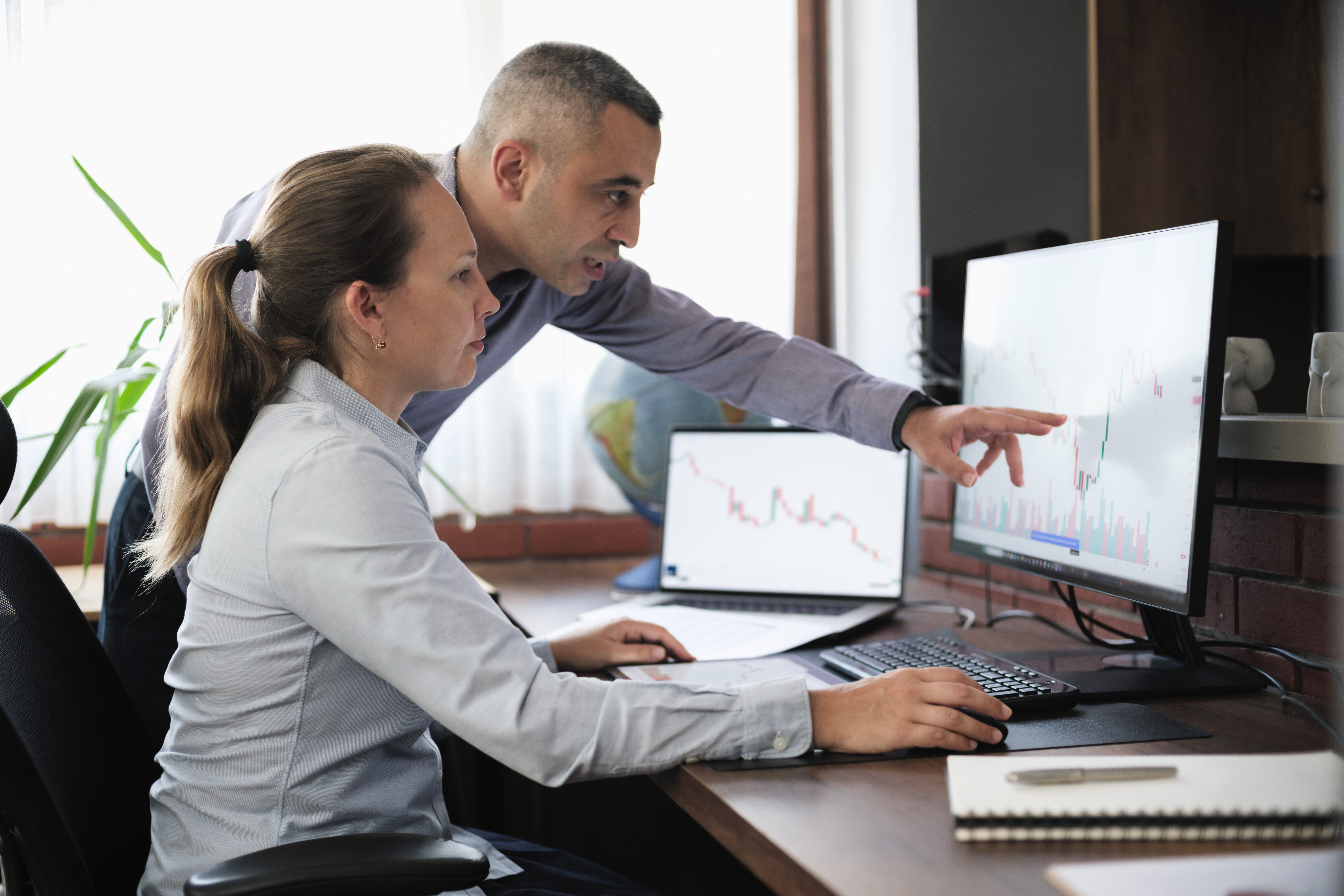 Two colleagues looking at a computer 