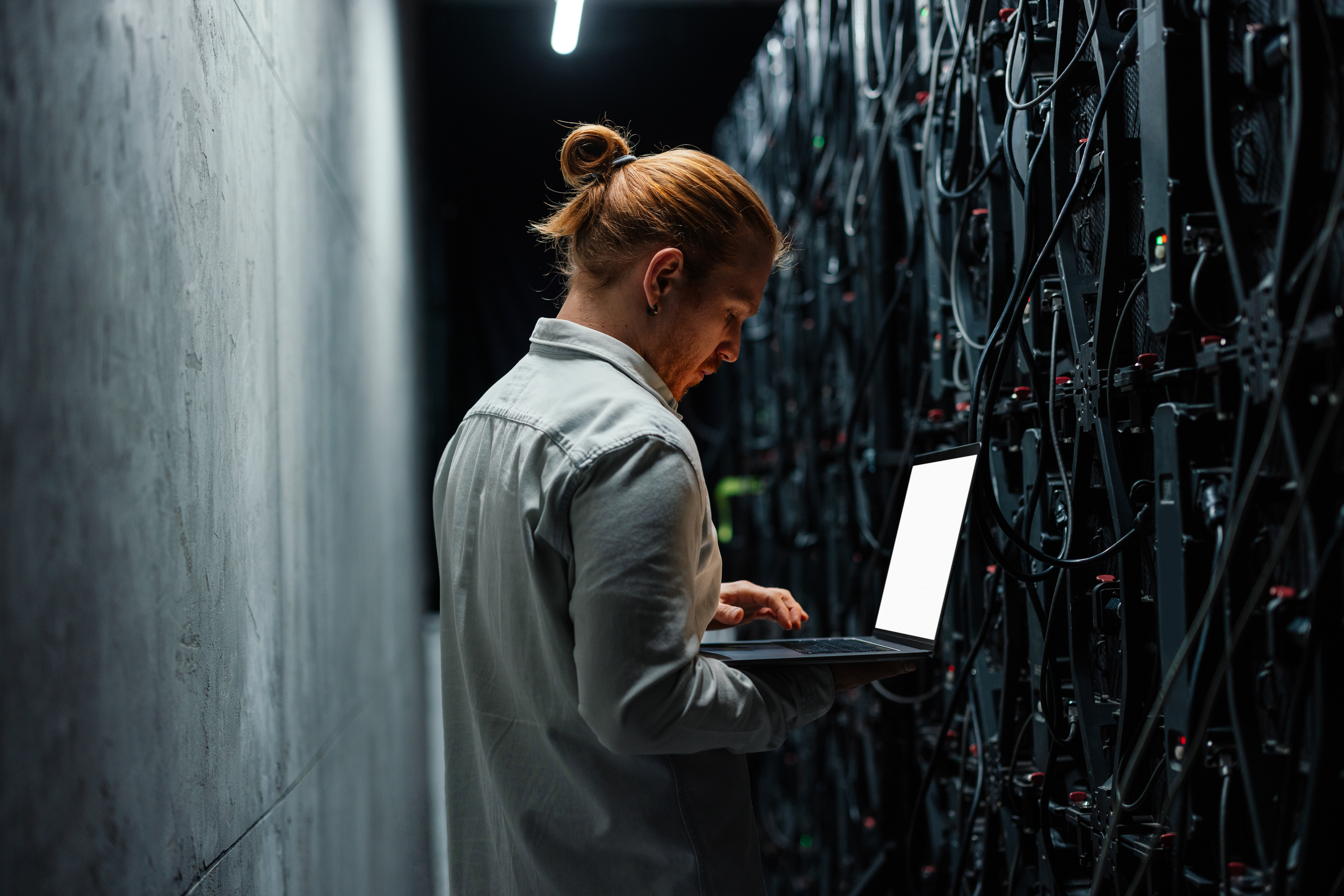 Employee working in server room
